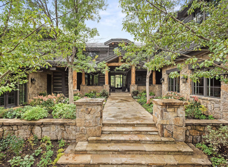 This stunning property boasts a beautiful stone facade and a welcoming entrance.