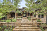 This stunning property boasts a beautiful stone facade and a welcoming entrance.