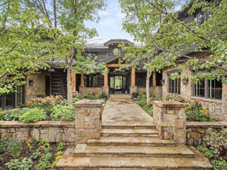 This stunning property boasts a beautiful stone facade and a welcoming entrance.