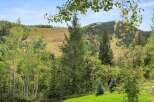 Nestled amidst the serene beauty of nature, this property offers breathtaking views of lush greenery and rolling hills.