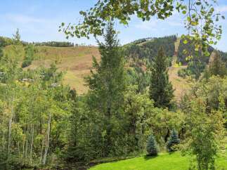 Nestled amidst the serene beauty of nature, this property offers breathtaking views of lush greenery and rolling hills.