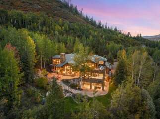 Nestled amidst a lush, tree-filled landscape, this stunning property offers a luxurious retreat.