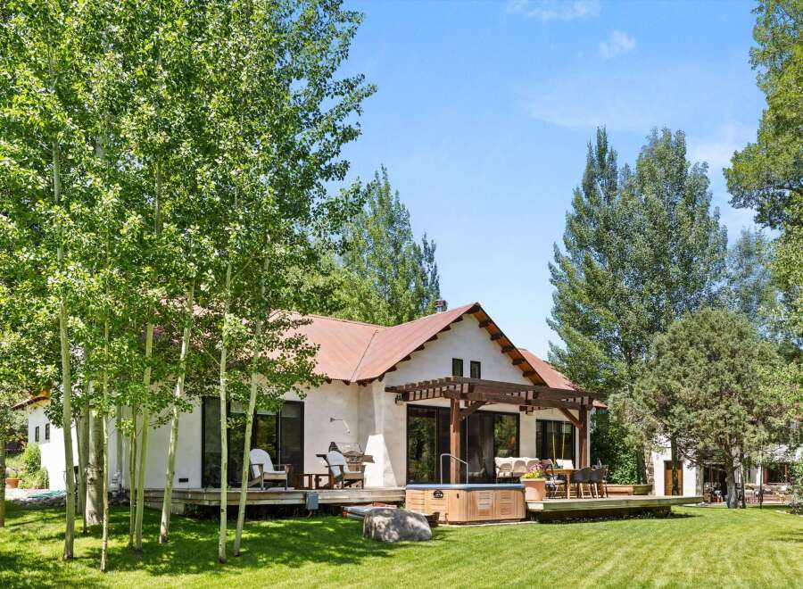 Escape to your dream retreat! This stunning property boasts a charming exterior with a rustic metal roof and a spacious deck, perfect for outdoor living.