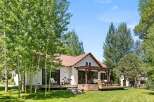 Escape to your dream retreat! This stunning property boasts a charming exterior with a rustic metal roof and a spacious deck, perfect for outdoor living.