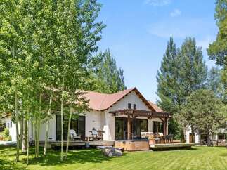 Escape to your dream retreat! This stunning property boasts a charming exterior with a rustic metal roof and a spacious deck, perfect for outdoor living.