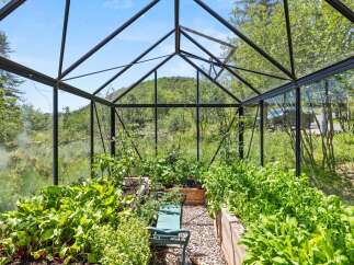 This stunning property boasts a beautiful greenhouse, perfect for cultivating your own fresh produce.