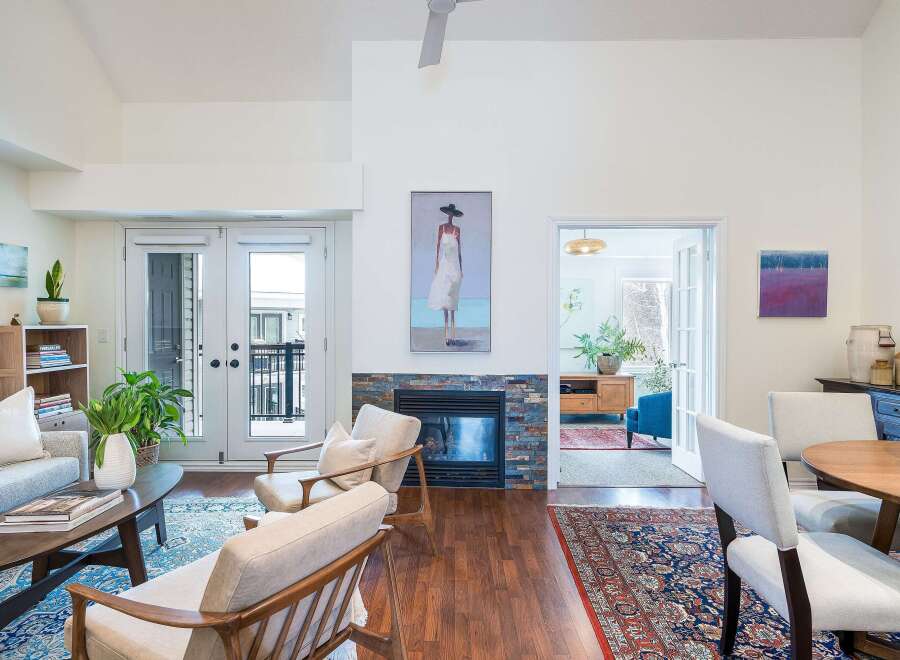Step into luxury with this stunning property, featuring a cozy fireplace and elegant hardwood floors.