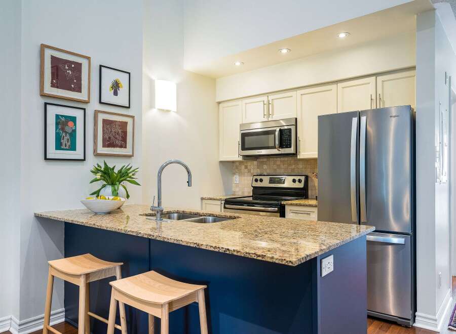 This stunning kitchen boasts a modern design with a spacious island, perfect for meal preparation and entertaining.