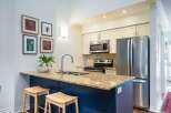 This stunning kitchen boasts a modern design with a spacious island, perfect for meal preparation and entertaining.