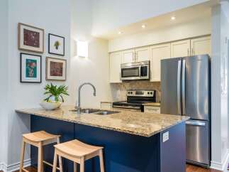 This stunning kitchen boasts a modern design with a spacious island, perfect for meal preparation and entertaining.