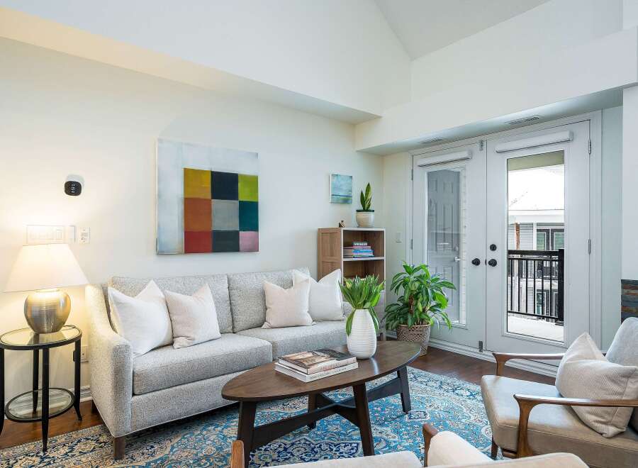 Step into luxury with this stunning living space! Featuring a modern design, this home boasts a cozy sofa, elegant coffee table, and a beautiful rug.