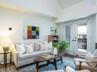 Step into luxury with this stunning living space! Featuring a modern design, this home boasts a cozy sofa, elegant coffee table, and a beautiful rug.