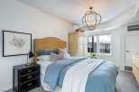 This bedroom offers a serene retreat with its soft color palette and inviting ambiance.