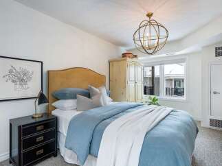 This bedroom offers a serene retreat with its soft color palette and inviting ambiance.