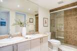 This stunning bathroom features a modern design with a spacious shower and elegant vanity.