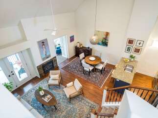 This stunning property boasts a spacious, open-concept living area with soaring ceilings and abundant natural light.