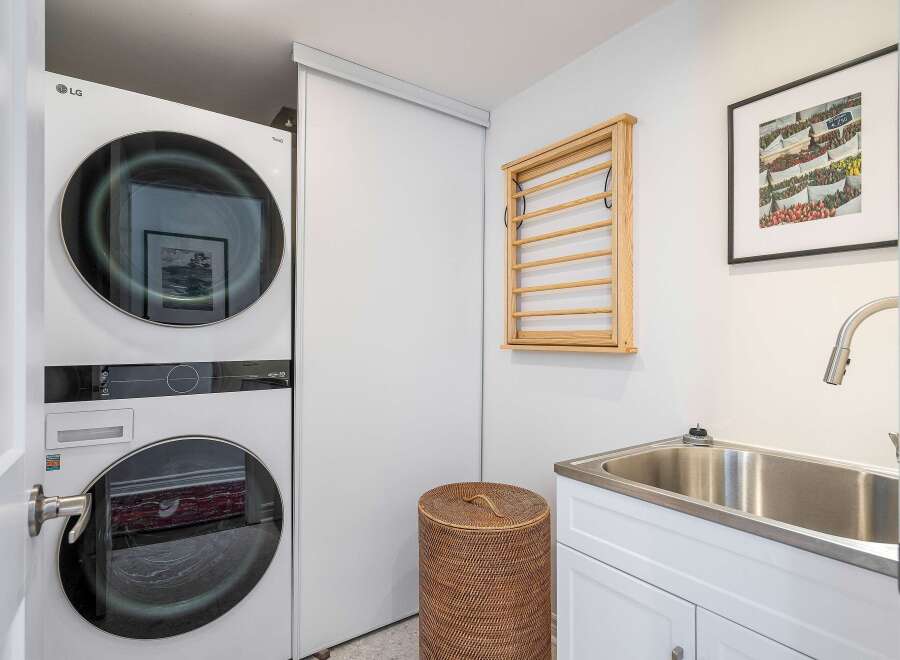 This modern laundry room features a sleek, stacked LG washer and dryer, maximizing space and efficiency.