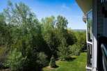 Enjoy breathtaking views of lush greenery and a vibrant blue sky from this stunning property.