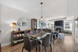 Step into luxury with this stunning property, featuring a modern dining area with a glass table and sleek chairs.