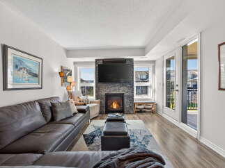 Step into luxury with this stunning living room! Featuring a cozy fireplace, a large TV, and a comfortable leather sofa, this space is perfect for relaxing or entertaining.