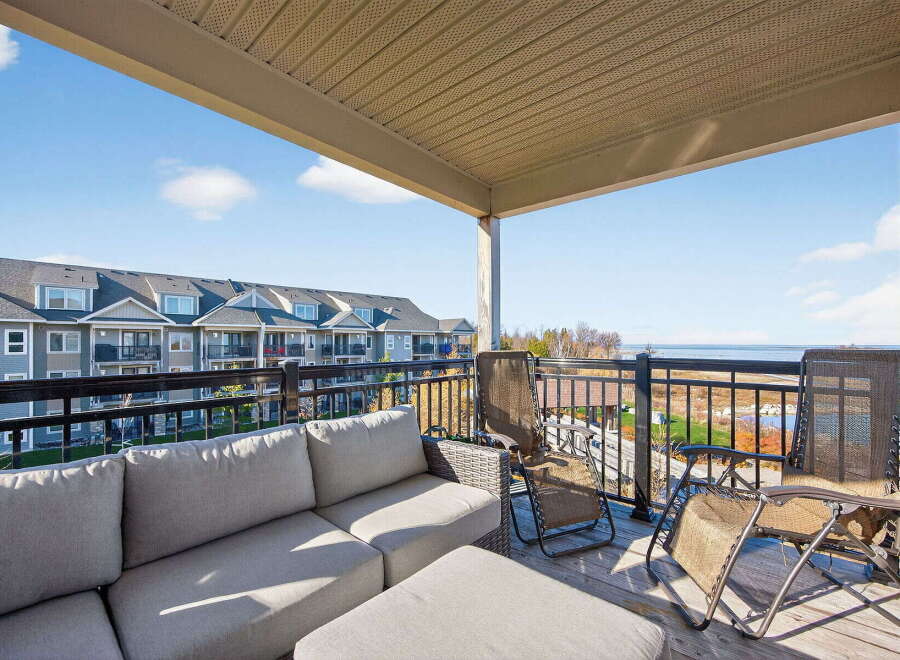 Enjoy breathtaking views from this stunning balcony overlooking the water.