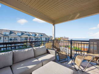 Enjoy breathtaking views from this stunning balcony overlooking the water.