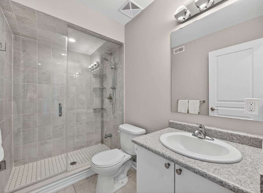 Step into this modern bathroom featuring a sleek glass-enclosed shower and elegant tile work.