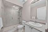Step into this modern bathroom featuring a sleek glass-enclosed shower and elegant tile work.