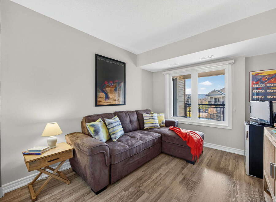 This cozy living space features a comfortable sectional sofa, perfect for relaxing.