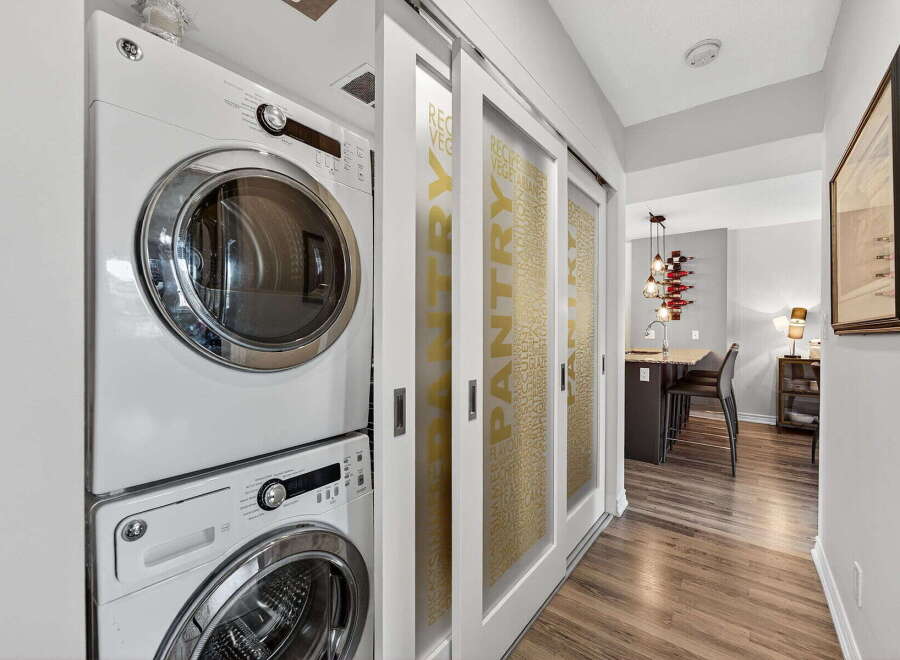 Discover modern living in this stylish property, featuring a convenient laundry area with a stacked washer and dryer.