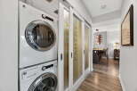 Discover modern living in this stylish property, featuring a convenient laundry area with a stacked washer and dryer.