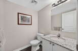 Step into this beautifully designed bathroom, featuring a stylish vanity with a granite countertop and a modern sink.