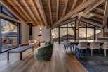 Experience luxury living in this stunning chalet, featuring a spacious open-plan design with exposed wooden beams and large windows that offer breathtaking mountain views.