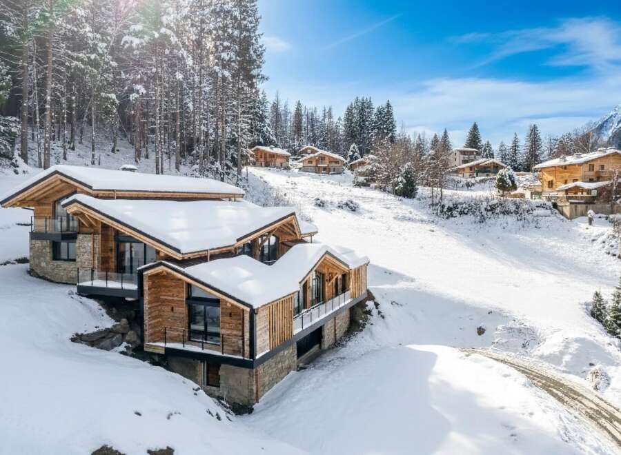 Discover the epitome of alpine luxury in this stunning chalet nestled amidst a snowy landscape.