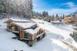 Discover the epitome of alpine luxury in this stunning chalet nestled amidst a snowy landscape.