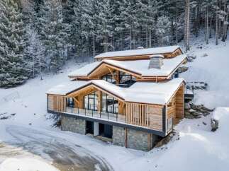 This stunning mountain home showcases a beautiful blend of natural materials and modern design.