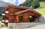 Experience the charm of this stunning wooden chalet nestled in a picturesque mountain landscape.