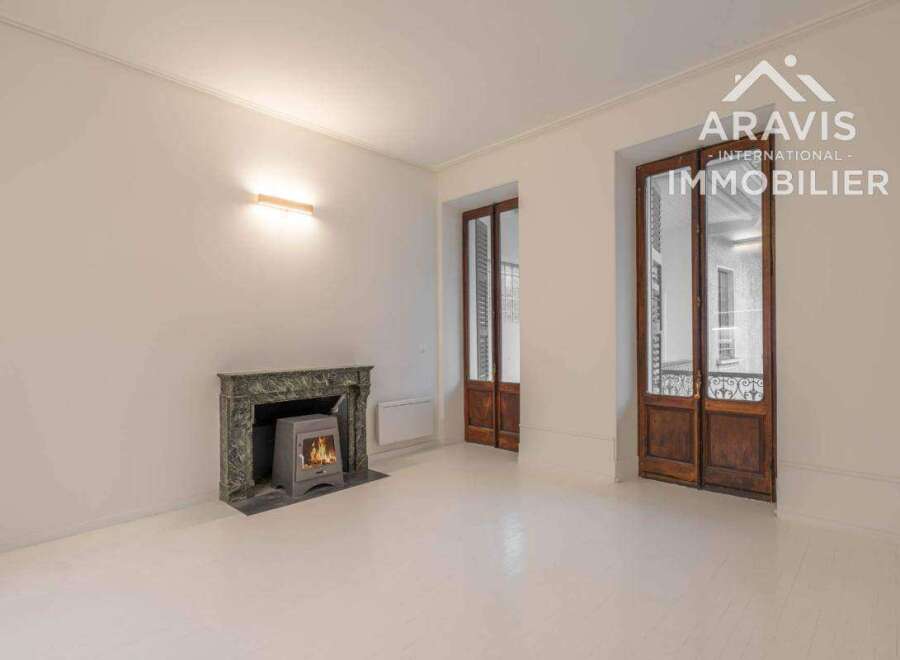 Discover this charming property featuring a cozy fireplace and elegant wooden doors.