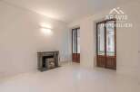 Discover this charming property featuring a cozy fireplace and elegant wooden doors.
