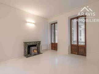 Discover this charming property featuring a cozy fireplace and elegant wooden doors.
