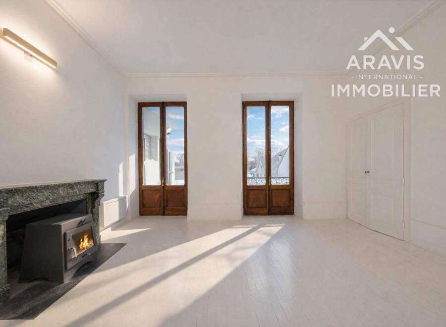 Discover the charm of this stunning property, featuring a cozy fireplace and elegant wooden doors.