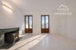 Discover the charm of this stunning property, featuring a cozy fireplace and elegant wooden doors.