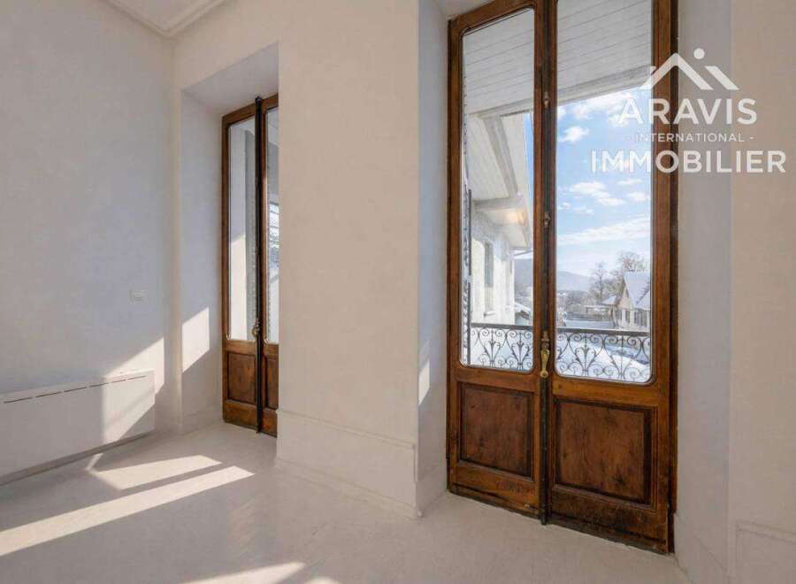 Discover the charm of this exquisite property, featuring elegant wooden doors that lead to a breathtaking view.