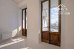 Discover the charm of this exquisite property, featuring elegant wooden doors that lead to a breathtaking view.