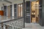 Discover the charm of this exquisite property, featuring elegant shutters and a beautifully crafted wrought iron balcony.