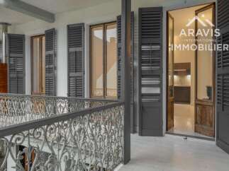 Discover the charm of this exquisite property, featuring elegant shutters and a beautifully crafted wrought iron balcony.