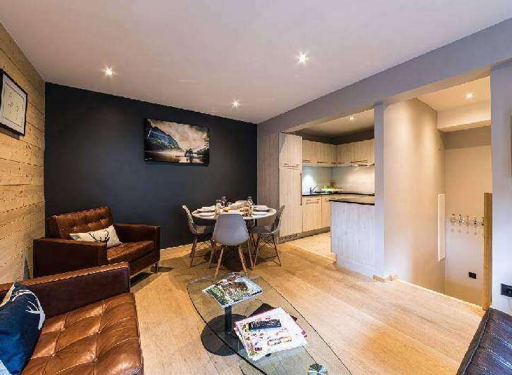 Discover the charm of this beautifully designed property, featuring a cozy living area with comfortable leather seating and a stylish glass coffee table.