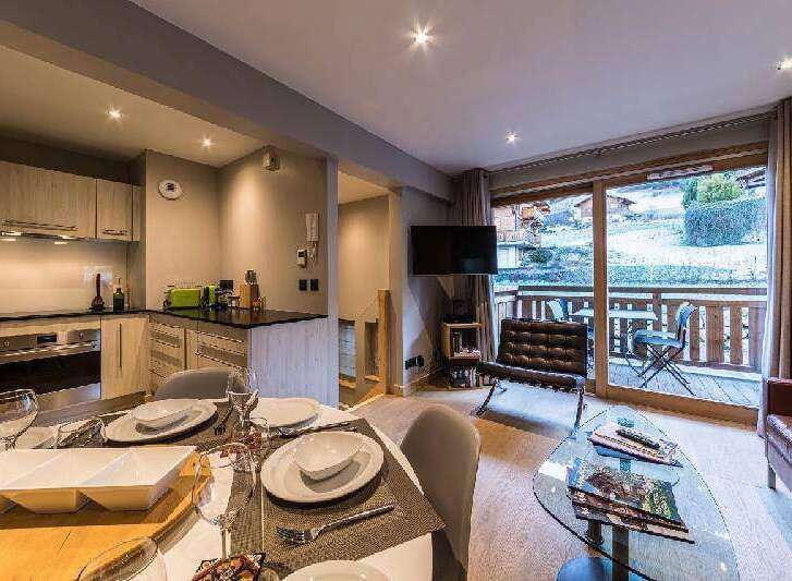 Experience luxury living in this stunning property, featuring a modern kitchen and a cozy living area.