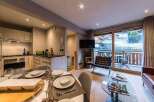Experience luxury living in this stunning property, featuring a modern kitchen and a cozy living area.