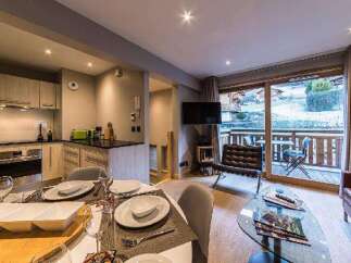 Experience luxury living in this stunning property, featuring a modern kitchen and a cozy living area.